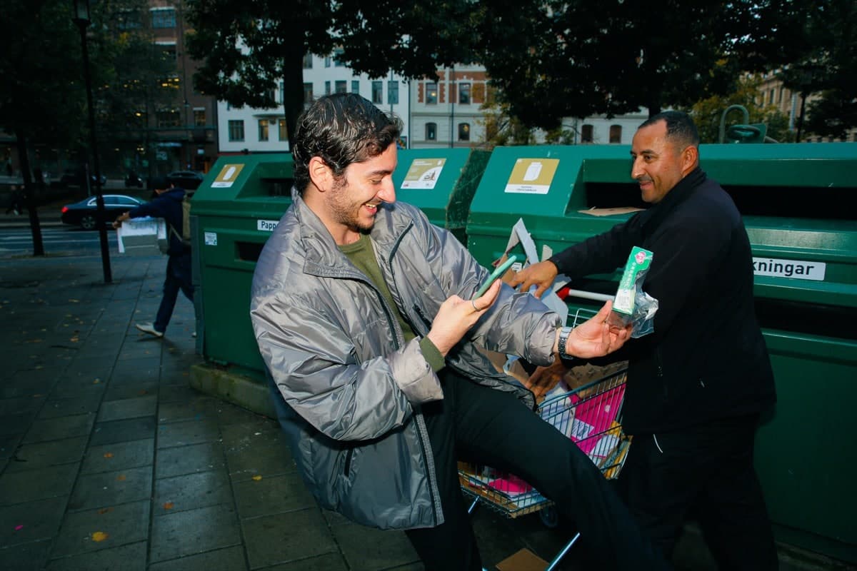 People recycling with Bower at green bins