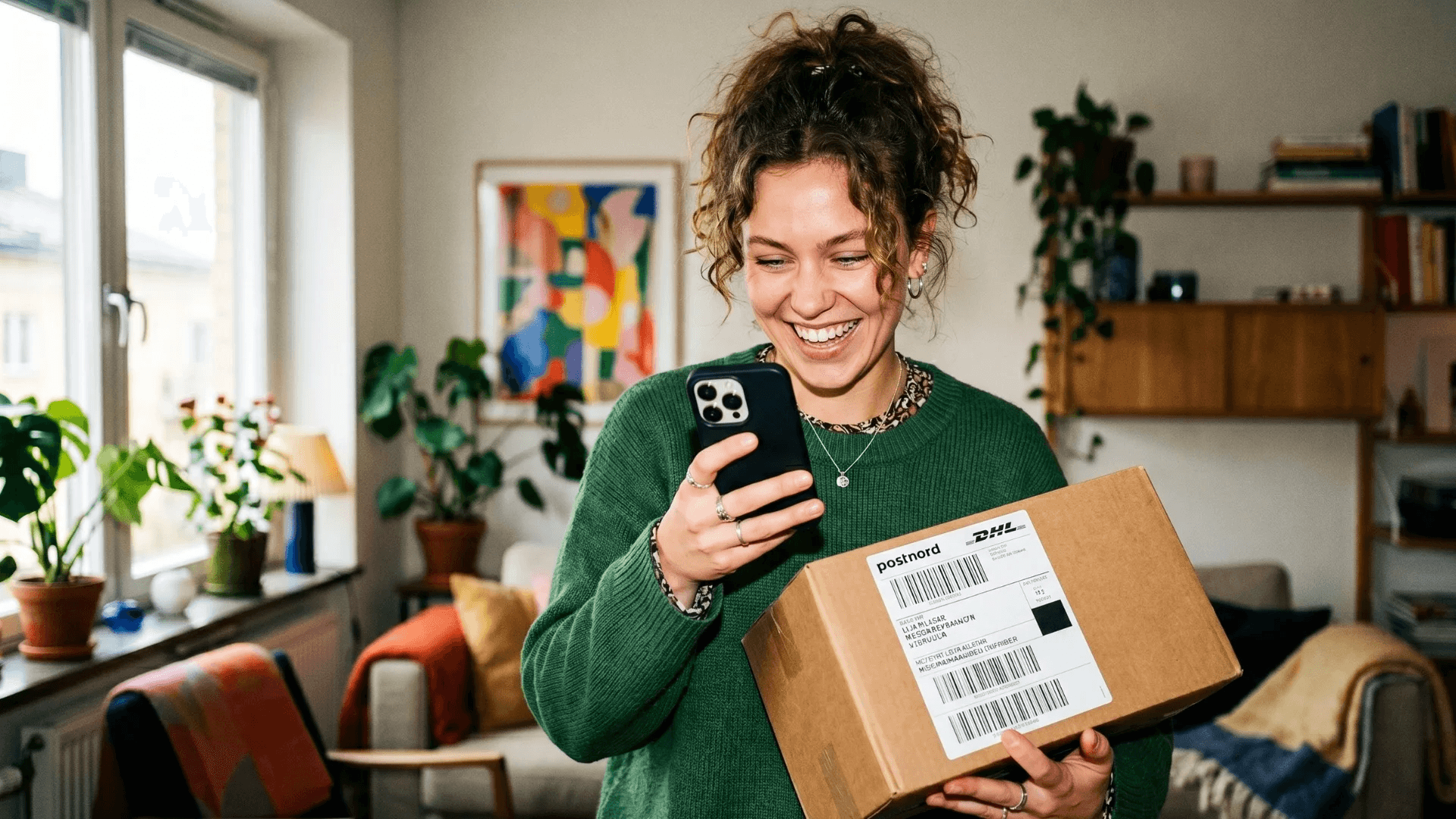Person holding a shipping box and scanning with Bower